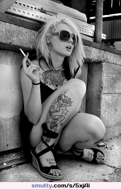 #blonde #sunglasses #smoking #crouching #spacer #tattoos #legs #thighs #sandals #barefeet #toes #chestpiece #outfoors