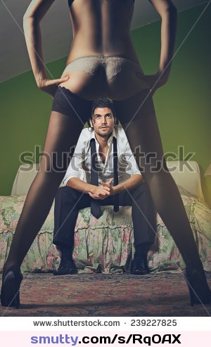Fashion man looks at woman with sensual legs . Seduction and passion concept