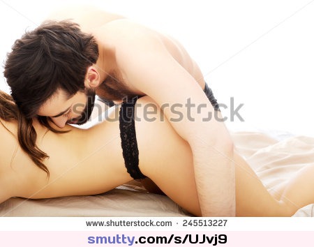 Young beautiful couple having foreplay in bedroom.