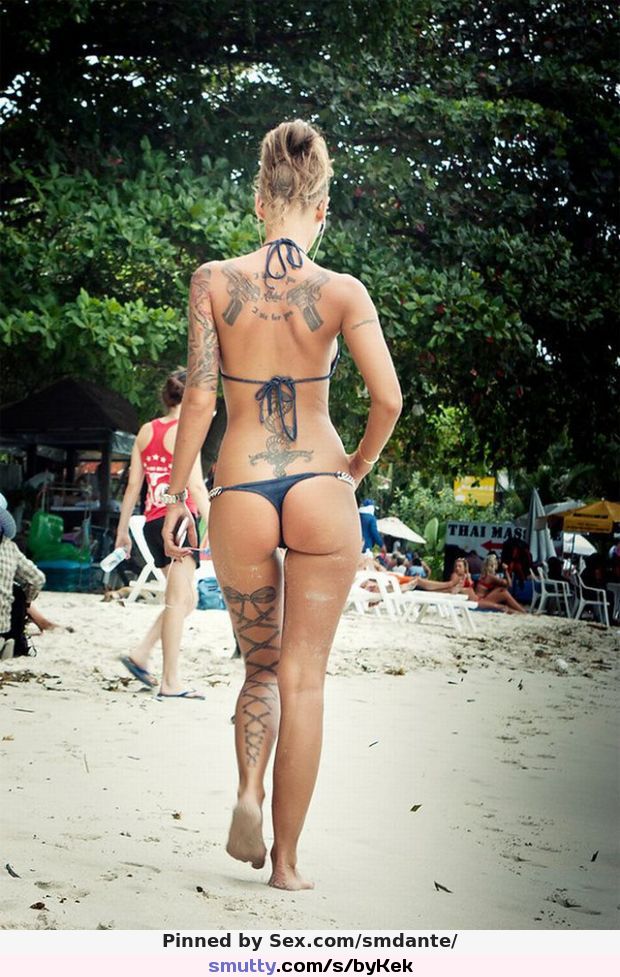 Tattooed sexy blonde beach babe